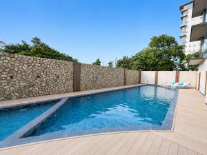 a swimming pool in a backyard with a fence at oneTree Plaza Hotel Cebu in Cebu City