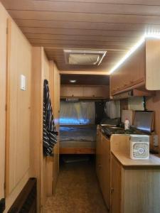 a small kitchen with a bed in a trailer at Full Service Caravan 2 in Gentofte