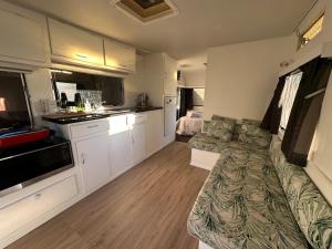 a living room with a couch and a kitchen at Henarata Homestead in Wakefield