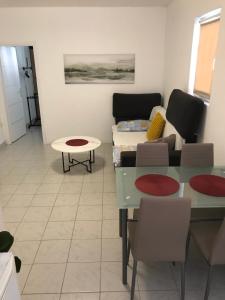 a living room with a couch and a table at Apartments Gumla 1 in Stara Novalja +10 photos