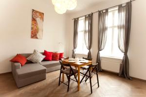 a living room with a couch and a table at Krakow Townhouse in Kraków