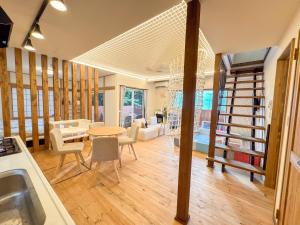a kitchen and living room with a table and chairs at Moro伊豆の国 in Izunokuni