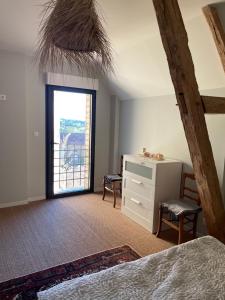 a bedroom with a bed and a dresser and a window at Eden in Ceton
