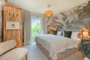 a bedroom with a bed and a large window at BALI BLIZZ - App 11 in Benz