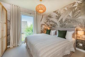a bedroom with a bed and a large window at BALI BLIZZ - App 11 in Benz