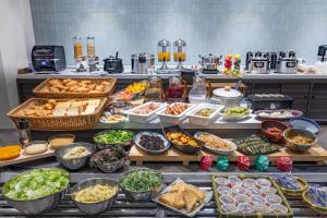 a buffet line with many different types of food at Hotel Keihan Sendai in Sendai
