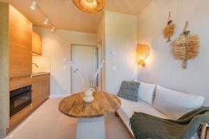 a living room with a table and a couch at BALI BLIZZ - App 12 in Benz