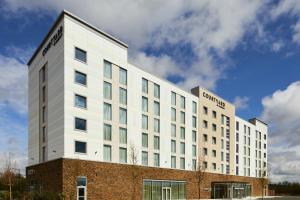 a white building with a sign on the side of it at Courtyard by Marriott Sheffield in Sheffield