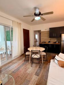 a living room with a table and a kitchen at Vittoria House Garden in Bayahibe