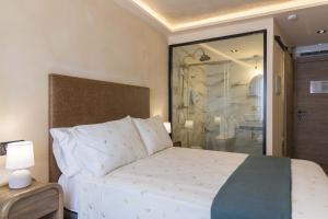 a bedroom with a bed and a glass shower at Artilles Suites in Peniscola +17 photos