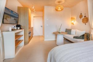 a bedroom with a bed and a couch and a table at BALI BLIZZ - App 14 in Benz