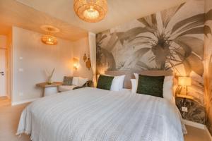 a bedroom with a large white bed and a wall mural at BALI BLIZZ - App 14 in Benz