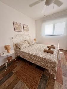 a bedroom with a bed and a window and a table at Vittoria House Garden in Bayahibe