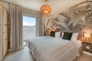 a bedroom with a bed and a large window at BALI BLIZZ - App 15 in Benz