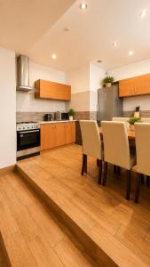 a kitchen with a dining room table and chairs at Pokoje Bielsko in Bielsko-Biała