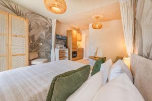 a bedroom with a large white bed with a couch at BALI BLIZZ - App 16 in Benz