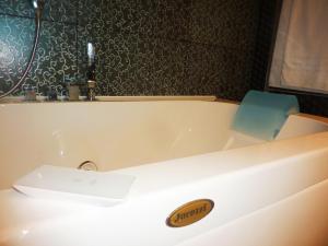 a bathroom with a bath tub with a sink at Hotel Palladio in Giardini Naxos