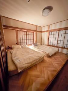 two beds in a room with two windows at Moro伊豆の国 in Izunokuni +34 photos