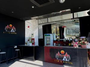 a restaurant with a counter and stools in a room at Lyn's Hotel Da Lat in Da Lat