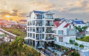 a rendering of a white building in a city at Lyn's Hotel Da Lat in Da Lat