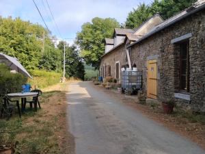 an empty road next to a brick building at Le Mont Rochard in Sainte-Gemmes-le-Robert