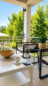 a patio with a table and chairs on a porch at Villa Conceptt casa in Jasenak