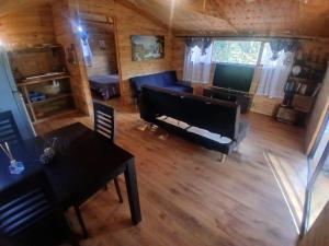 an aerial view of a living room with a piano at Diamond Vault Rustic Mountain Cabins in Hogsback