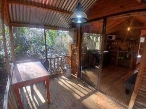 an inside view of a cabin with a wooden deck at Diamond Vault Rustic Mountain Cabins in Hogsback