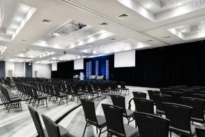 a room with rows of chairs and a stage at Perdido Beach Resort in Orange Beach