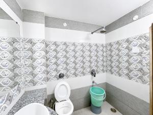 a bathroom with a toilet and a blue bucket at Hotel SVD HARIDWAR in Haridwār +22 photos