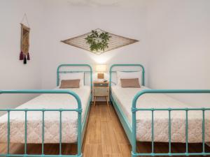 two twin beds in a room with white walls at Marelia Memories villa in Skaleta +35 photos