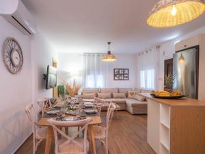 a dining room and living room with a table and chairs at Marelia Memories villa in Skaleta