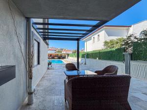 a patio with a table and chairs and a pool at Easy Stay Mia Suites in Aydın