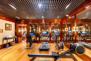 a gym with several treadmills and exercise equipment at J.K. Place Paris in Paris