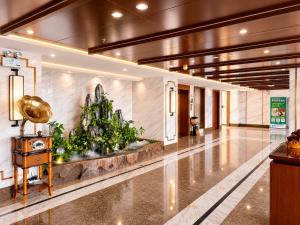 a lobby with a christmas tree in the middle at Rose Garden International Hotel in Phnom Penh