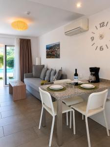 a living room with a table and a couch at Alsol Los Leones Bungalows - Adults Only in Maspalomas