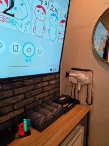 a projection screen with a hair dryer on a counter at 힐링모텔 in Inch'ŏn-yŏk