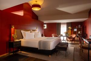 a hotel room with a bed and a table at Margaret - Hôtel Chouleur in Nîmes +118 photos