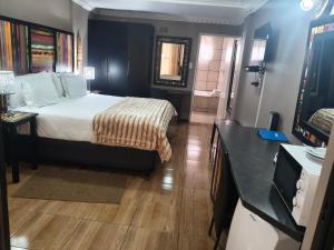 a hotel room with a bed and a bathroom at Blyde Lodge in Graskop