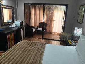 a bedroom with a bed and a living room at Blyde Lodge in Graskop +61 photos