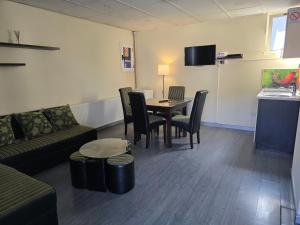 a living room with a couch and a table and chairs at Apartman Galerija in Užice