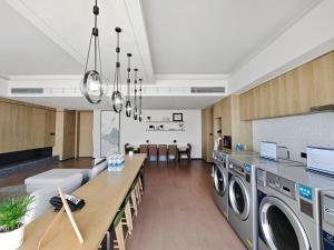 a kitchen and living room with a washer and dryer at Element by Marriott Guangzhou Baiyun in Guangzhou