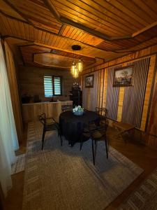 a dining room with a table and chairs in a room at Садиба Володар in Kosiv