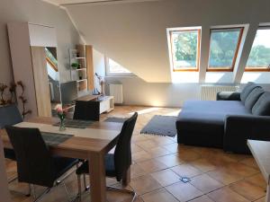 a living room with a table and a couch at Kincs apartman in Győr +13 photos