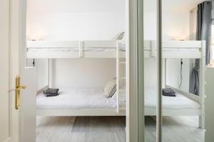 a room with two bunk beds and a door at Beachfront Apt Torrox Costa in Torrox +17 photos