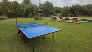 a ping pong table in a yard with a poolricular at Le Paisible Atlas in Marrakesh