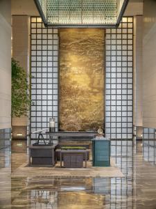 a lobby of a building with a wall at Guangzhou Marriott Hotel Baiyun in Guangzhou