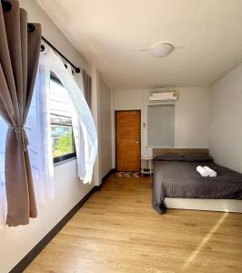 a bedroom with a bed and a window at D sleep Home Chiangmai in Chiang Mai