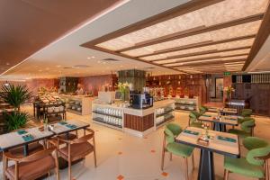 a rendering of a restaurant with tables and chairs at Somerset Hoa Binh Hanoi in Hanoi