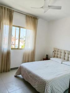 a bedroom with a large bed and a window at Casa Cristina in Vinarós